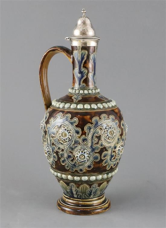 George Tinworth for Doulton Lambeth, a scroll and flowerhead design silver-topped ewer, dated 1874, 30cm